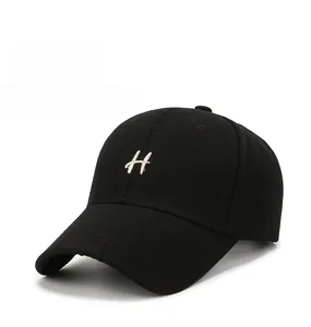 Detailed embroidery of the white letter H on a black cotton twill baseball cap