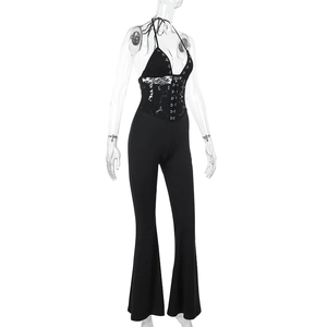 Detailed view of the halter neck lace bodice and slim fit waist on a black jumpsuit