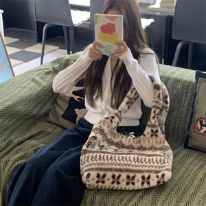 Close-up of fluffy plush tote bag with ethnic geometric pattern in soft autumn setting