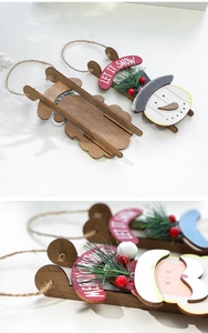 Detail of wooden snowman on skateboard ornament with Let It Snow and Merry Christmas text