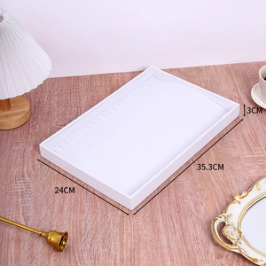 White jewelry display tray showing dimensions 35.3cm x 24cm x 3cm on wooden background
