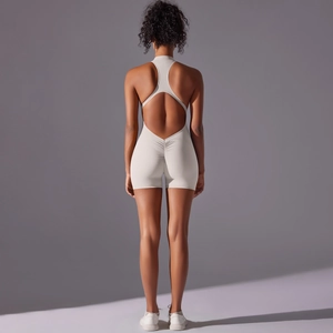 Detailed back view of beige one-piece yoga romper featuring a scrunch butt and racerback