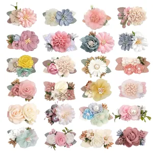 Collection of 24 colorful artificial flower hair clips with roses and daisies in a grid view