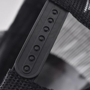 Close-up of the adjustable plastic snapback closure and breathable black mesh on the cap