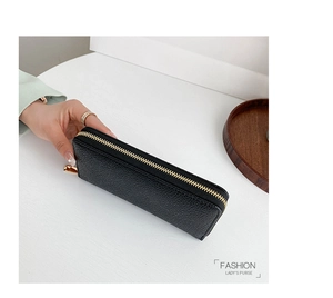 Side view of black lychee grain leather wallet featuring a premium gold metal zipper