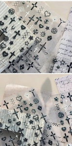 Macro view of gothic cross and star nail stickers with black glitter details