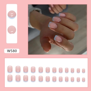 Short French press-on nails in light blue and pink with a glossy cream finish