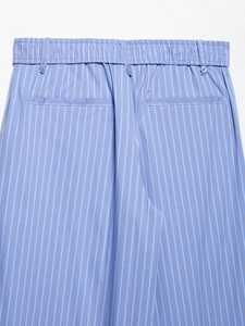 Detail of blue striped trousers with elastic waistband, belt loops and rear welt pockets