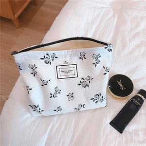 Detail of floral bubble cotton pouch with TIME TO PARTY label and black rose pattern