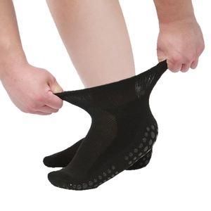 Elastic black diabetic socks with non-slip grip soles for men and women shown in detail