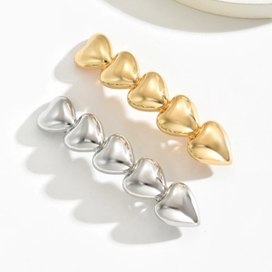 Minimalist gold and silver metallic heart hair clips with five linked charms in a row