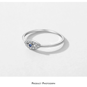 Detailed close-up of S925 silver Evil Eye ring with blue gemstone and micro-pave crystals