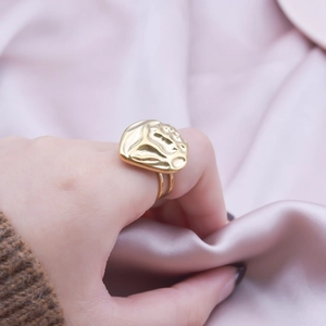 Minimalist 304 stainless steel golden ring with hammered texture on pink silk