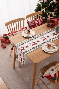 Detailed pattern of reindeer and snowflakes on a festive Christmas table runner