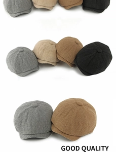 Flat lay of knit newsboy caps in grey, beige, brown, and black wool blend textures