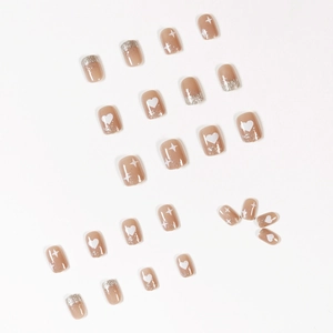 Short square nude press-on nails with white heart, star patterns and silver glitter tips