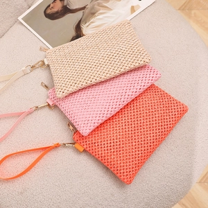 Straw woven beach wristlet bags in beige, pink and orange with metallic zippers