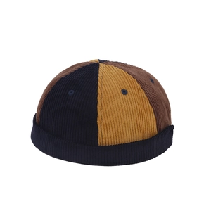 Three-color patchwork corduroy docker cap in navy blue, mustard yellow, and brown tones