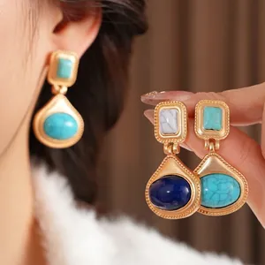 Vintage gold oval resin earrings with semi-precious stones shown on model