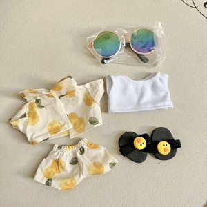 Detail of yellow lemon print doll outfit set with tiny sandals and sunglasses