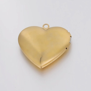 Detailed close-up of a polished gold heart-shaped locket pendant on a white background