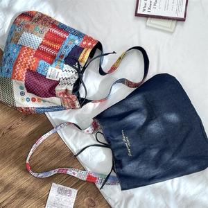 Detail of ethnic patchwork tote and navy denim drawstring bags with shoulder straps