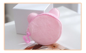 Detailed view of pink plush round coin purse with cute ears and a functional zipper hook