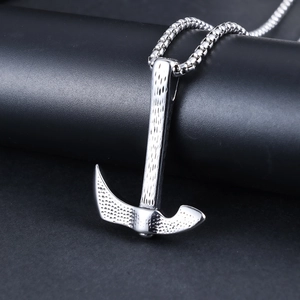 Vintage stainless steel axe pendant with hammered texture and rugged chain on black background