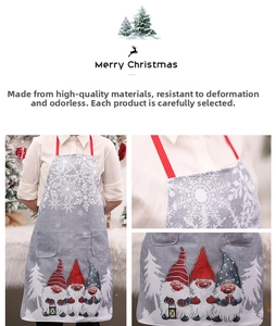 Detail of Christmas gnome linen apron showing festive snowflake prints and large pockets