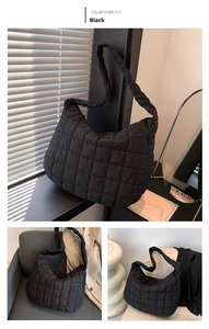 Detail showing the quilted grid texture and padded strap of the black cloud tote bag
