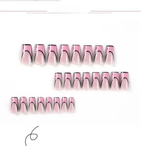 Detailed view of pink gradient press-on nails with black comic-style outlines