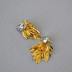 Modern mixed metal leaf tassel earrings with silver liquid texture and golden foliage