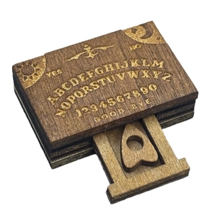 Miniature wooden ouija board with sliding planchette and detailed alphabet engraving