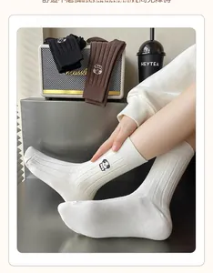 Detailed embroidery of a cartoon dog on a knit cotton mid-tube sock for women