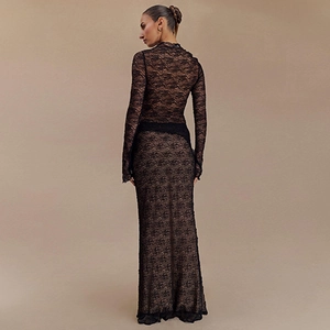 Detail of black lace long-sleeve maxi dress showing sheer floral texture and slim back fit