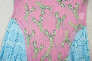 Detail of pink and blue mesh dress featuring lobster print and geometric bubble patterns