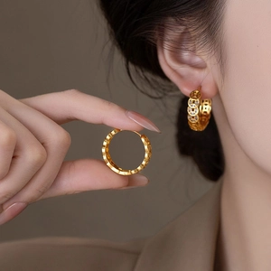 Gold plated hoop earrings with hollow ancient coin pattern and cubic zirconia accents