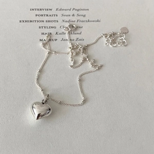 Detailed macro view of 925 sterling silver heart pendant necklace with polished finish