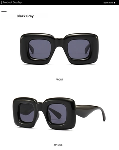 Front and 45 degree side view of thick black square sunglasses with grey lenses