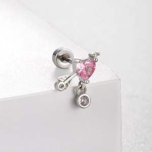 Titanium steel heart earring with pink gemstone and arrow element on white background