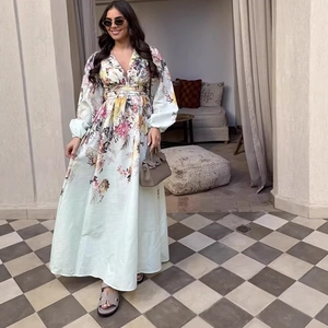 Floral print long sleeve maxi dress with V-neck and cinched waist on a model