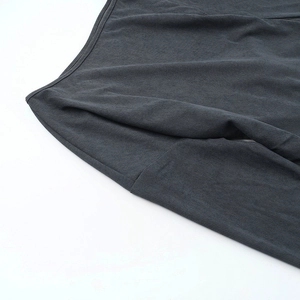 Close-up detail showing the dark grey ribbed knit texture and soft fabric of the women's top