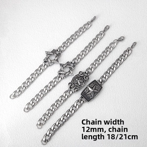 Detailed view of 12mm wide stainless steel Cuban chain bracelet with star charms