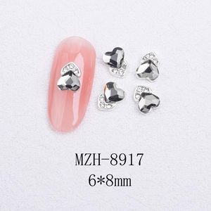 Detailed close-up of a 6x8mm heart-shaped cat's eye nail charm with a silver alloy base
