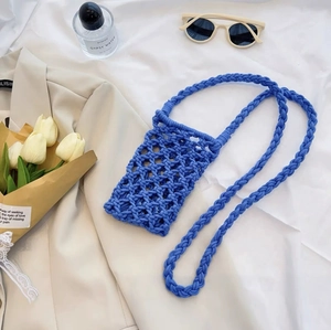 Detail of blue hand-woven cotton rope mini crossbody phone bag with hollow mesh design