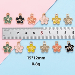 Mini cherry blossom alloy charms 15x12mm with ruler for size and scale reference
