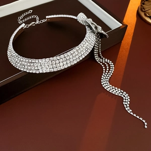 Detail of silver rhinestone choker necklace featuring a flower bow and cascading tassels