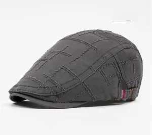 Detail view of distressed grey flat cap with quilted stitching and adjustable metal buckle