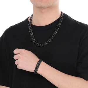 Detail of black hammered cuban chain necklace and bracelet set on a male model