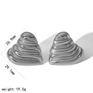 Detail view of silver heart earrings with ribbed texture and size 26.9mm x 29.1mm